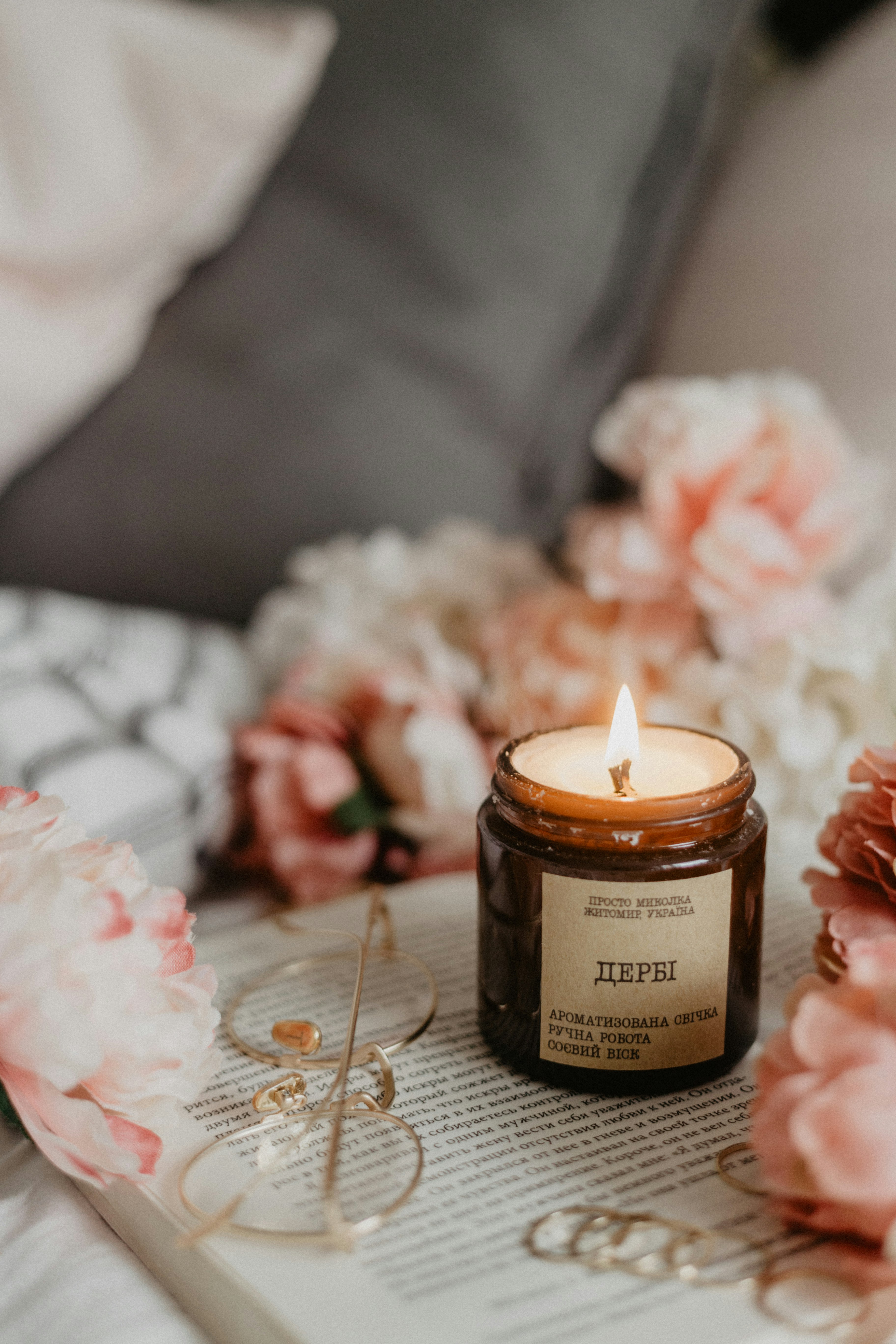 wax candle beside eyeglasses on book